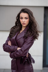 Modern feminine outfit with high-quality burgundy leather skirt and structured jacket styled for...