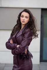 Modern feminine outfit with high-quality burgundy leather skirt and structured jacket styled for...