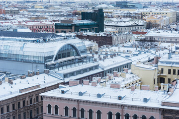 Old buildings roofs under the snow.