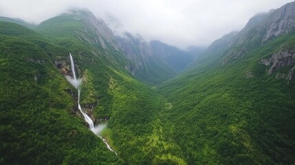 Aerial waterfall in green mountain valley
