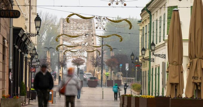 Győr, Hungary - November 10, 2024: Heartbeat of Győr: Jedlik &Aacute;nyos Street Bustles with Tourists and Local Charm. Timelapse, zoom out transition.