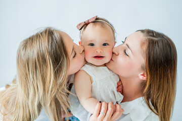 Happy young woman having fun playing with her daughters. Healthy parenting. Peaceful motherhood.