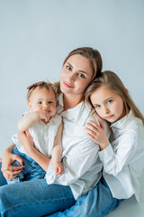 Happy young woman having fun playing with her daughters. Healthy parenting. Peaceful motherhood.