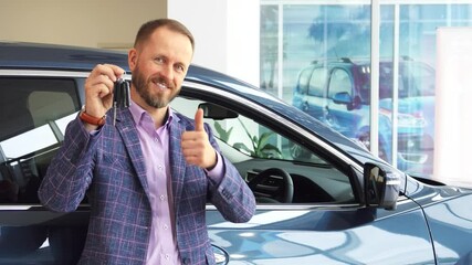 Confident car seller showcases quality vehicle with keys and a thumbs up