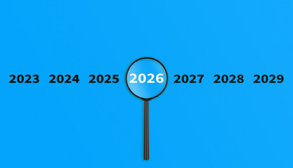 Lens, magnifying glass focusing on the year 2026 on a Blue background. Financial or stock market...