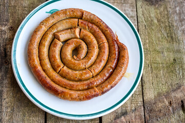 Grilled  pork  juicy sausages on wooden board outdoors. Grilling food, bbq, barbecue, picnic