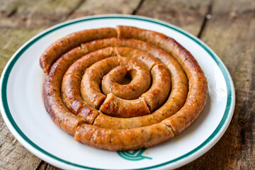 Grilled  pork  juicy sausages on wooden board outdoors. Grilling food, bbq, barbecue, picnic