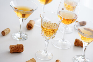 Set of glasses of yellow wine at wine tasting on white wooden table