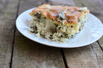   Rice shepherd's pie.   Rice and  Lamb meat  Casserole  with   parmesan cheese and garlic on wooden rustic background. 