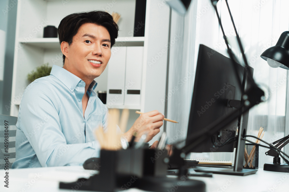 Poster portrait of smart businessman looking camera to pose while working on computer checking email wearin