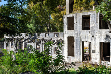 In bright sunlight, dilapidated abandoned stone buildings are visible in the famous southern resort...
