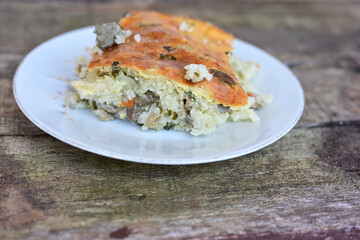   Rice shepherd's pie.   Rice and  Lamb meat  Casserole  with   parmesan cheese and garlic on wooden rustic bakcgound. 