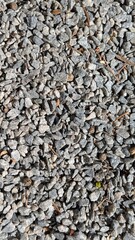Textured background of small gray stones. An excellent choice for websites, print materials, or as a base for design projects.