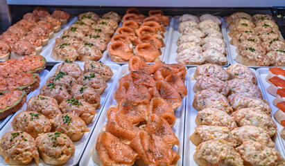 Assorted salmon tapas on display in Mercado de San Miguel, Madrid.