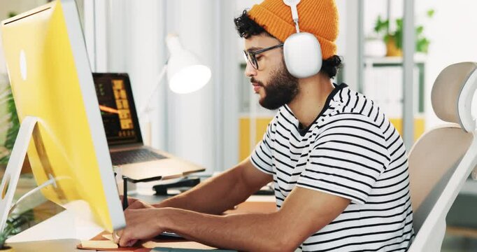 Office, businessman and computer with video call for notes, online training and creative agency. Career, male designer and smile with headphones for listening, writing information and virtual meeting