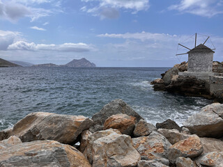 Traditional Windmill on the Rocky Coast of Amorgos Island, Greece – A Scenic View of the Aegean...