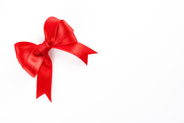 Red ribbon and bow on white background