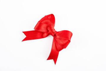 Red ribbon and bow on white background