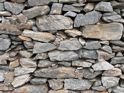 Close-up of traditional dry stone wall on Amorgos Island, Greece – rustic masonry texture of rough rocks, local architecture detail in Mediterranean Cycladic village setting