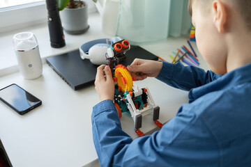 Child building a robotic toy at home
