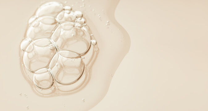 Close-up of transparent serum drops on a smooth surface