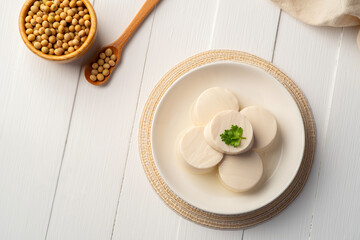 Fresh Sliced Soft Tofu soy bean curd on white plate.Top view