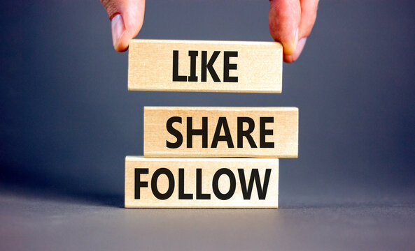 Like share follow symbol. Concept words Like Share Follow on beautiful wooden blocks. Beautiful grey background. Businessman hand. Business like share follow concept. Copy space.