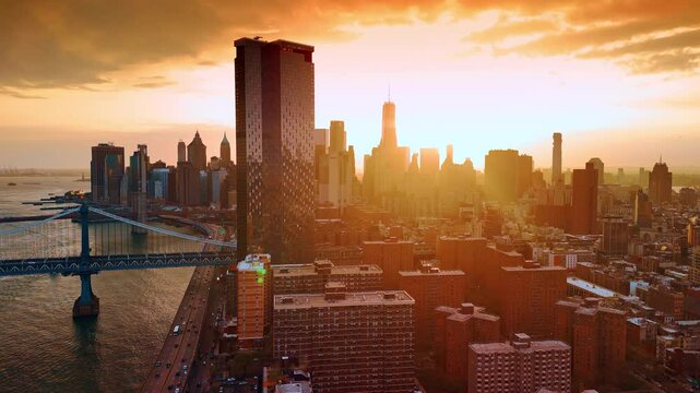 Amazing golden hour in modern New York. Sunset time footage from drone. Setting sun dazzles the scenery.