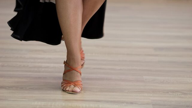 Professional dancer performing elegant footwork in studio