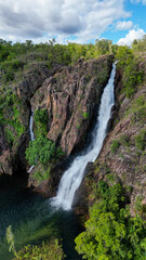 Obraz premium A waterfall and it´s pond in a remote area in NT Australia, seen from above