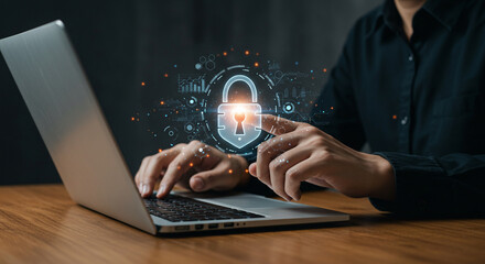 Person using laptop with digital padlock overlay for cybersecurity and data protection concept business, data