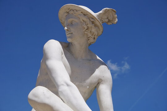 Side profile portrait of a white marble statue of Hermes or Mercury, the herald or messenger of the gods in Greek or Roman mythology, with his winged helmet