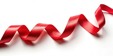 A vibrant red ribbon curls and twists gracefully on a blank white surface, ideal for decorative crafts, gift wrapping, or festive occasions. The smooth texture enhances its visual appeal