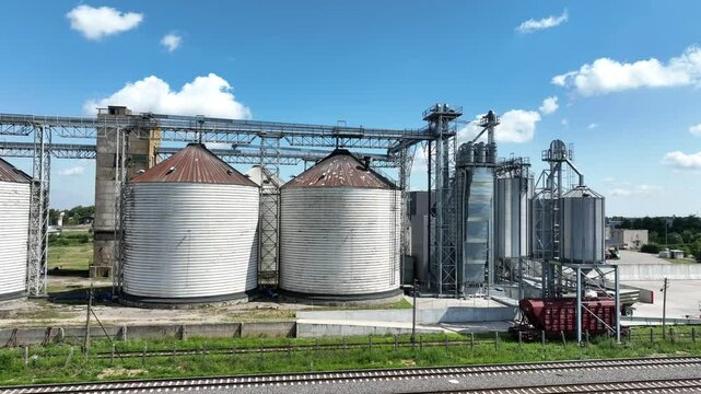 Agro-processing manufacturing plant for processing drying cleaning and storage of agricultural product, grain harvest. Modern silos. grain elevator facility. Large iron terminal of grain