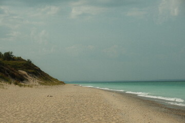 Aesthetic beach scenery with sand, water, clouds at Sleeping Bear Dunes National Lakeshore park in Michigan