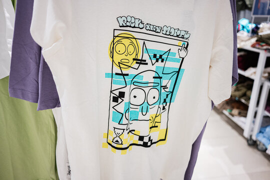 White T-shirt with Rick and Morty creative graphic print design featured in a retail clothing store