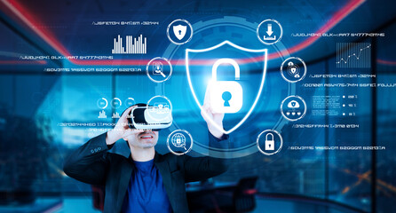 Project manager pointing security system hologram and standing at futuristic office with blue glowing color. Business man using augmented reality technology to connect and verify identity. Ingenuity.