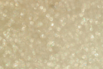 Sparkling golden glitter scattered across a surface during daylight