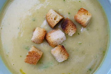 Close up of toasted croutons to be added to cream soup. Healthy eating, home cooking