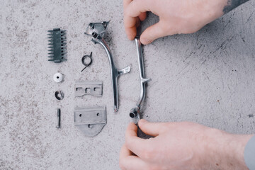  hands holding old hair clipper parts. classic hairdressing tools. traditional hairdressing art