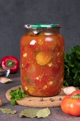 Cucumber and sweet pepper salad in tomato sauce in a glass jar