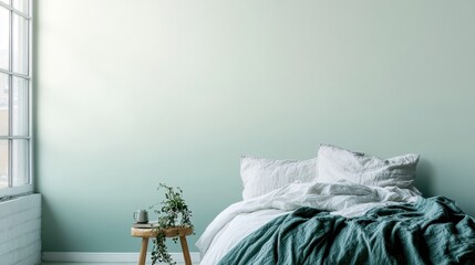 A calming bedroom with a soft teal gradient wall.