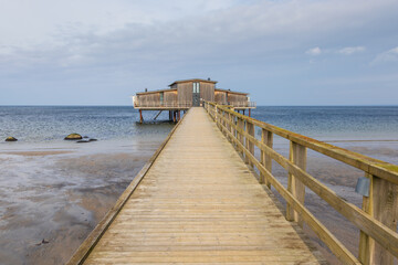 Fototapeta premium Wooden bathhouse on stilts over the sea in Torekov, Sweden.