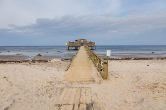 Wooden bathhouse on stilts over the sea in Torekov, Sweden.