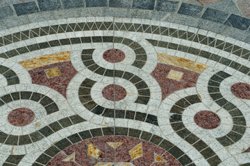 Mosaic floor with circular pattern made of stone or tiles 
