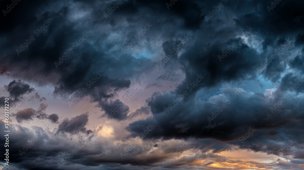 Poster dramatic sky image showcasing dark, textured clouds with hints of orange and purple hues at the hori