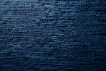 Deep blue textured surface, showing a rough, woven appearance suitable as a background for various design projects, conveying a sense of depth and sophistication