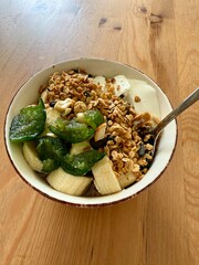 Porridge with granola banana, fig jam marmalade and sour cream
