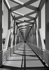 Horizontal image of a geometric bridge or walkway framed symmetrically.
