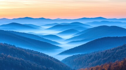 Fototapeta premium Misty mountain ranges at dawn